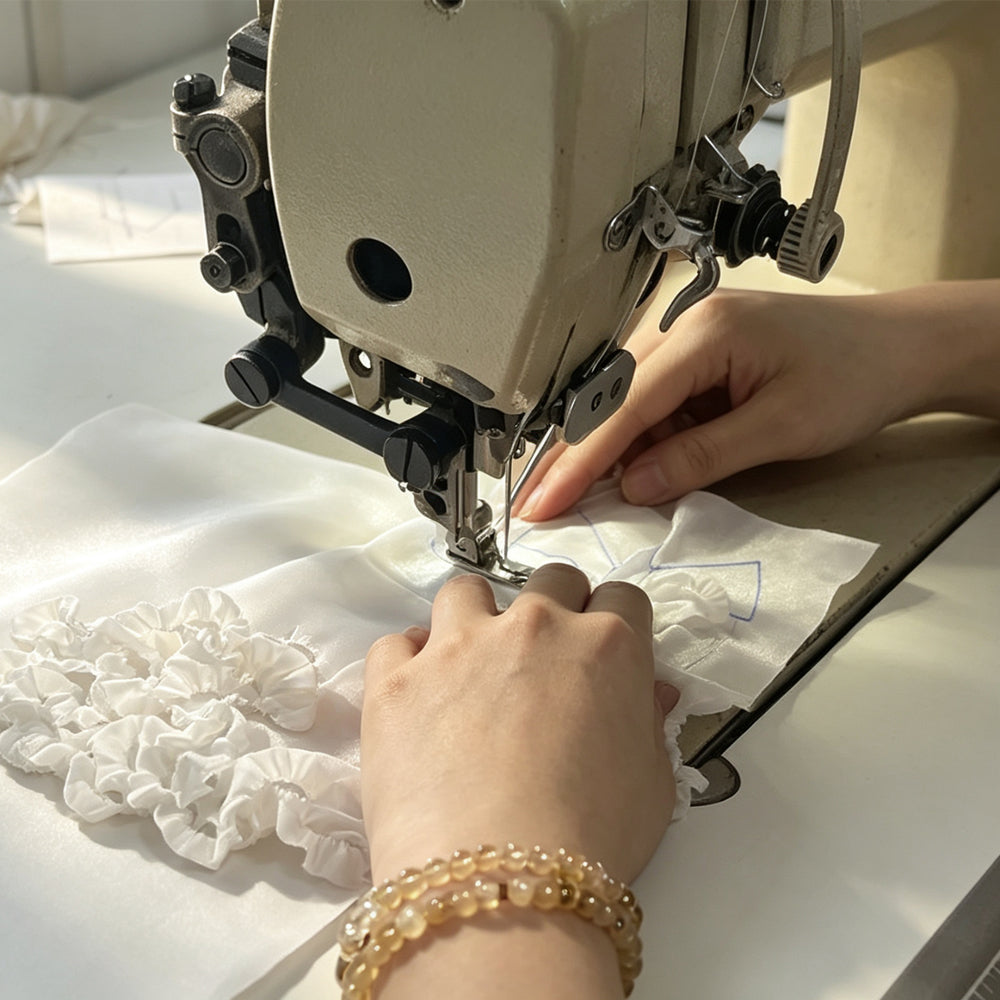 The designer is making sample clothes for the doll.